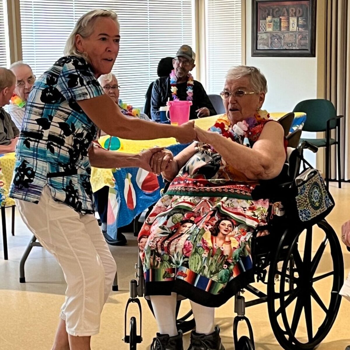 two seniors dancing, one in a wheelchair