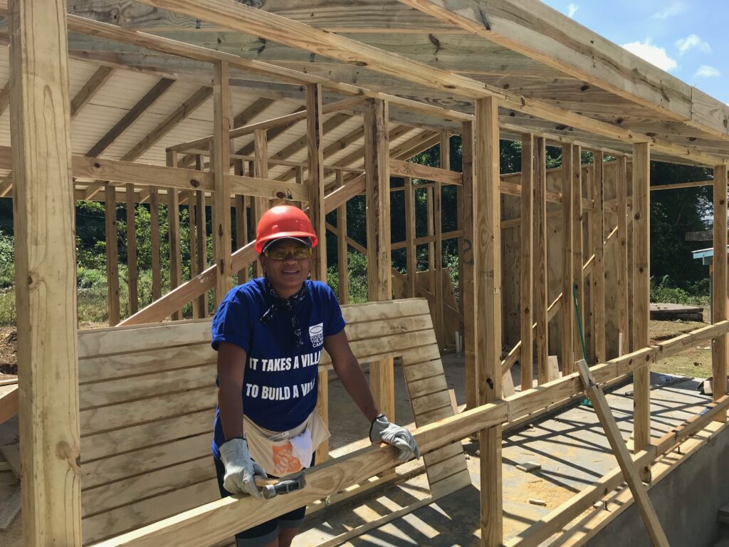 Habitat for humanity volunteer building a house