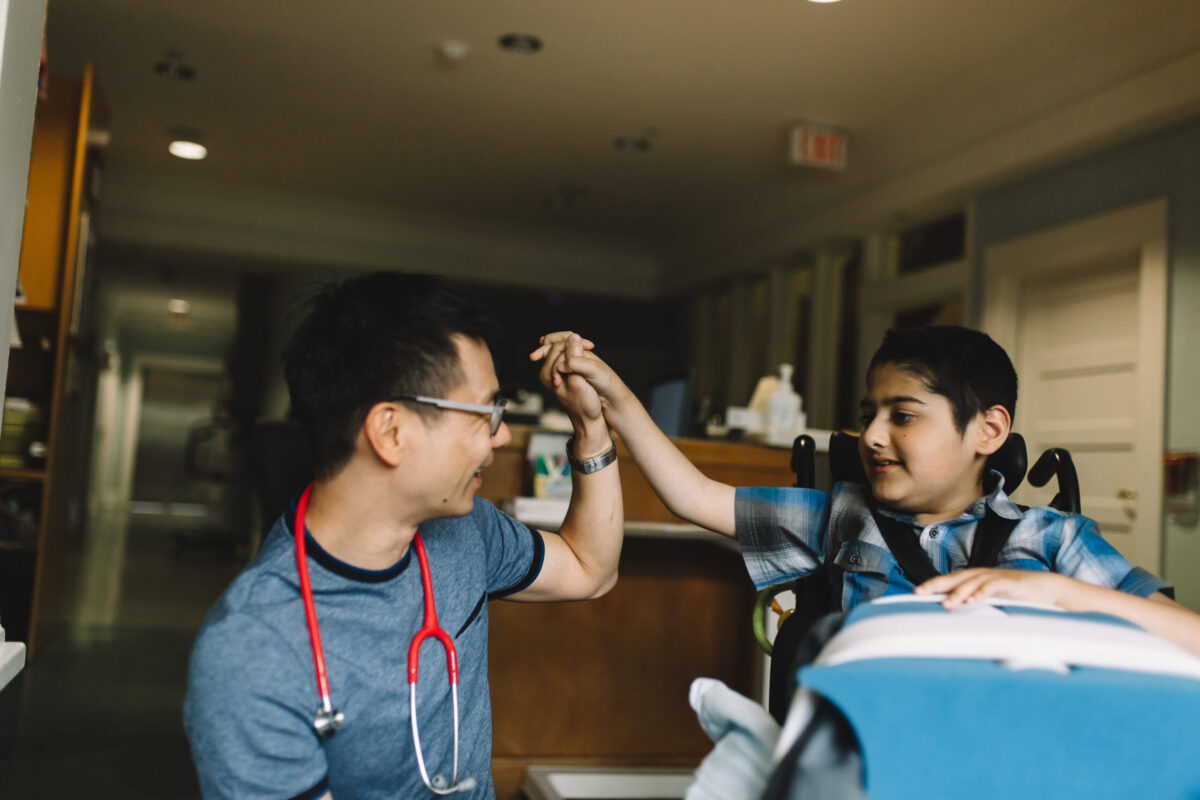 Dr Peter with a Canuck Place child