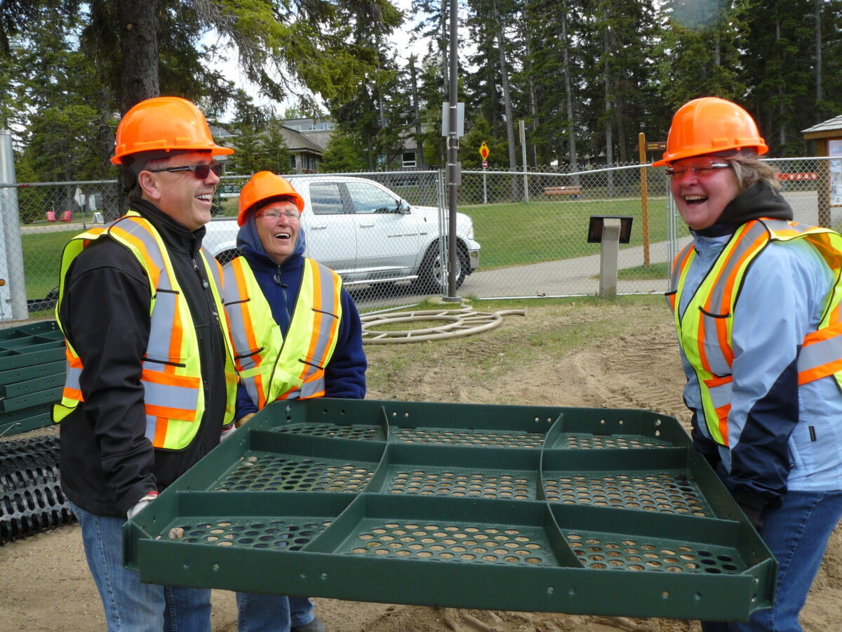 Volunteers work together during construction of the Bears on the Beach Playground at Waskesiu Lake
