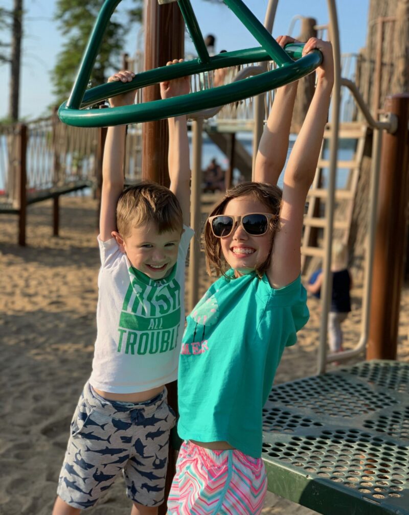 Kids playing on the Bears on the Beach playground at Waskesiu Lake