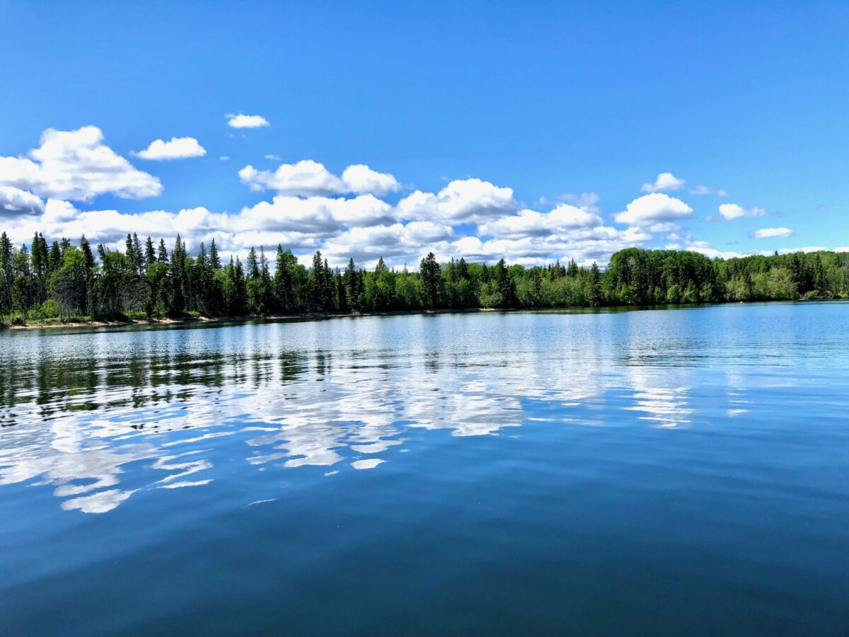 A beautiful photo of Waskesiu Lake reflected in the water