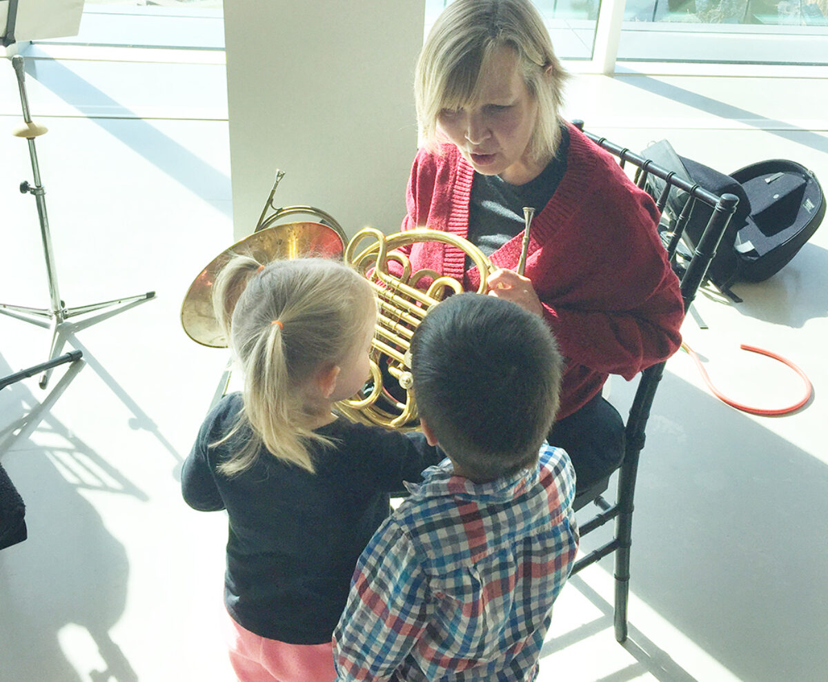 Children surround Horn Player at London Symphonia Cushion Concert at Museum London