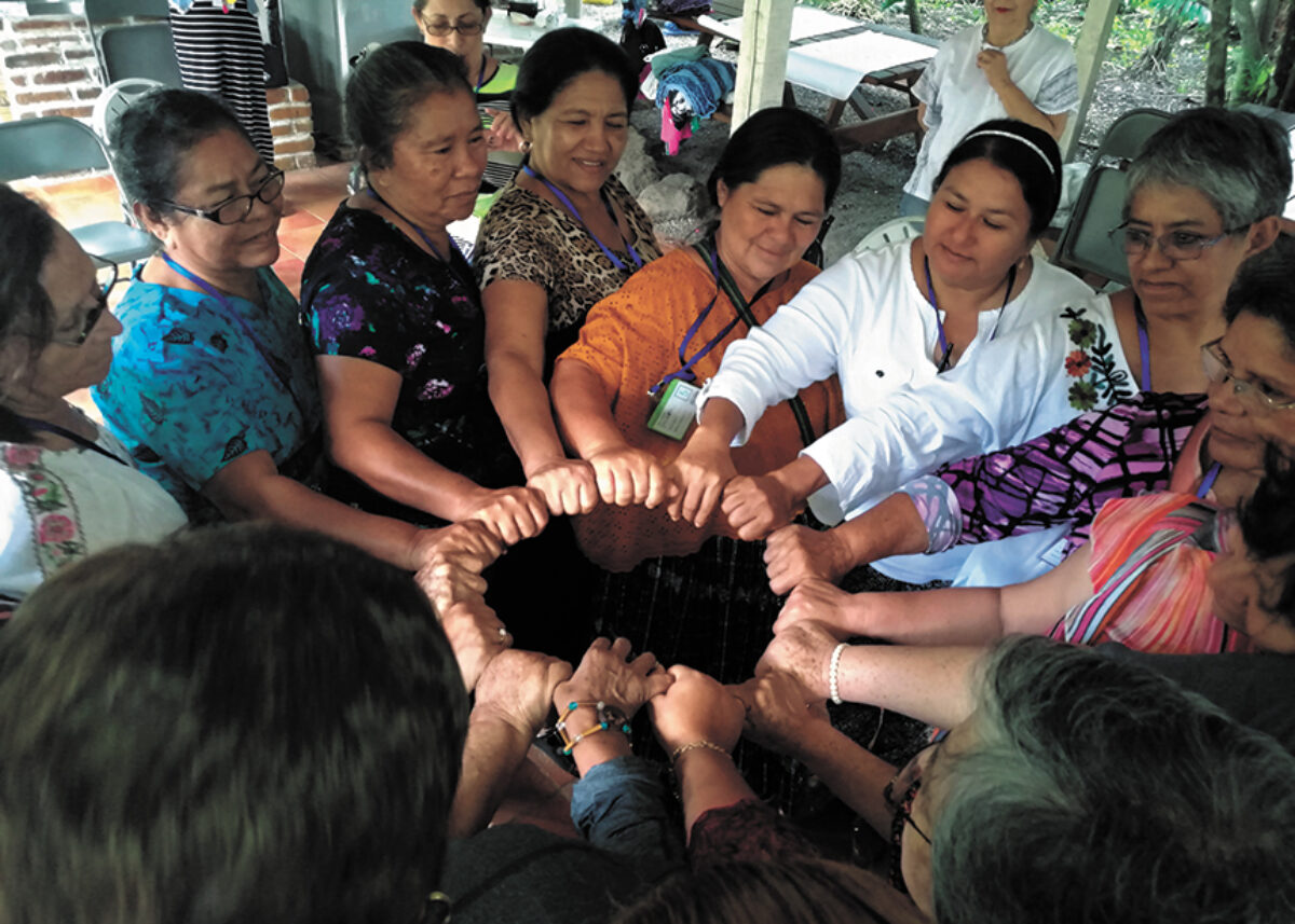 Women in circle, fists together
