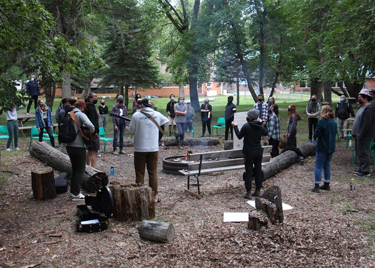 People around a campfire, singing