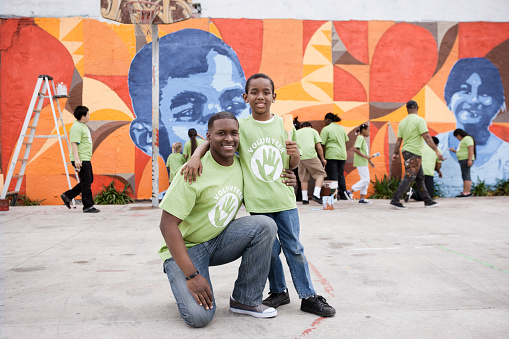 Father and son in front of wall art