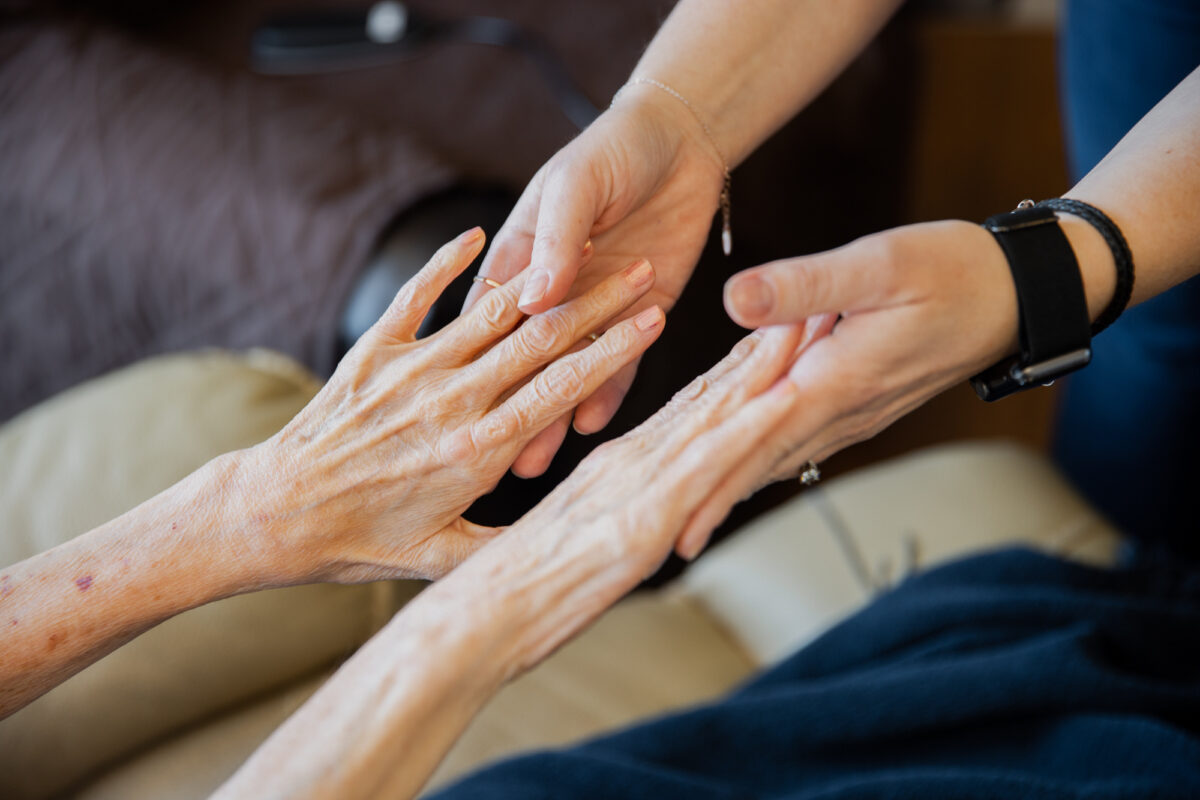 Two pairs of hands touching