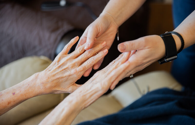 Two pairs of hands touching