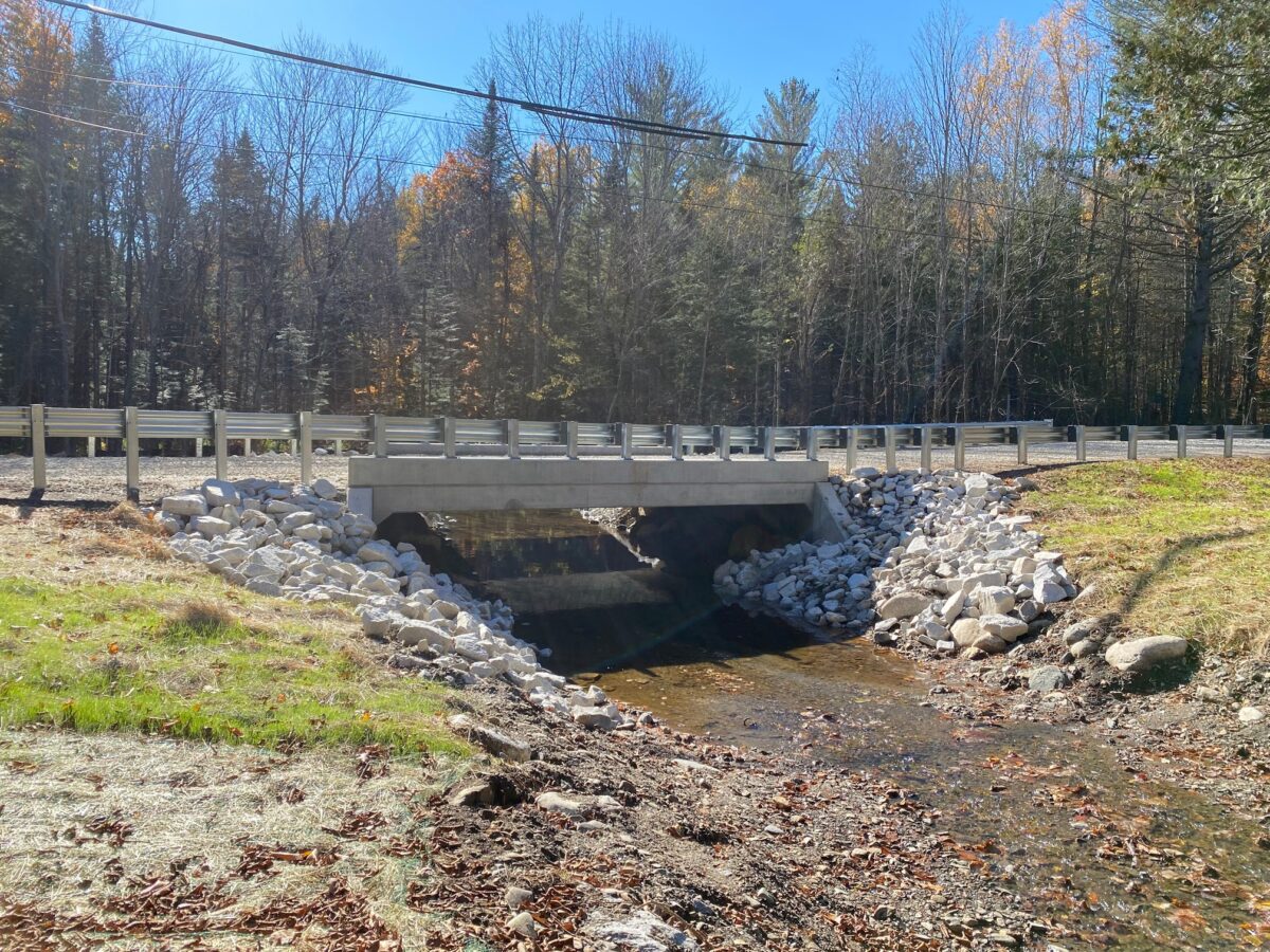 newly installed bridge with a free flowing stream below