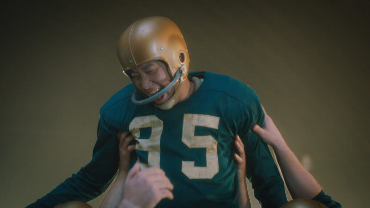 A football player being lifted by his team in celebration.